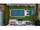 Bird's eye view of elegant backyard pool featuring fire bowls, lounge chairs and outdoor entertaining space at 7165 Cordery Rd, Cumming, GA 30040