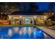 Stunning pool and outdoor living space with large windows and modern design under string lights at 7165 Cordery Rd, Cumming, GA 30040