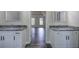 Elegant bathroom featuring double vanities, granite countertops, and sleek black hardware at 863 Fairlong Nw Way, Acworth, GA 30101