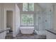Relaxing bathroom with a freestanding tub, walk-in shower, and generous natural light at 863 Fairlong Nw Way, Acworth, GA 30101