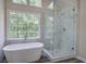 Spa-like bathroom featuring a modern shower, freestanding tub, and picturesque window views at 863 Fairlong Nw Way, Acworth, GA 30101