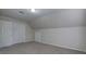 Spacious bedroom with neutral walls, carpet, double door closet and attic space at 863 Fairlong Nw Way, Acworth, GA 30101