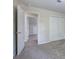 Bedroom with neutral walls, carpet, and doors to closet and attic spaces at 863 Fairlong Nw Way, Acworth, GA 30101