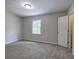 A bedroom with neutral walls and carpet, natural light from one window, and a closet at 863 Fairlong Nw Way, Acworth, GA 30101