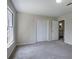 Carpeted bedroom featuring double door closet, bright window, and entry to the bathroom at 863 Fairlong Nw Way, Acworth, GA 30101