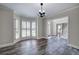 Spacious dining room featuring hardwood floors, shuttered windows, modern lighting, and view into foyer at 863 Fairlong Nw Way, Acworth, GA 30101