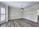 Dining room with hardwood floors, shuttered windows, modern lighting, and view into other rooms at 863 Fairlong Nw Way, Acworth, GA 30101