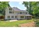 Rear exterior view of a two-story home featuring a patio and lush, green lawn at 863 Fairlong Nw Way, Acworth, GA 30101