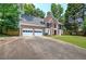 Two-story brick home with a two-car garage, long driveway and well-maintained lawn and landscaping at 863 Fairlong Nw Way, Acworth, GA 30101