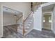 Spacious foyer boasts hardwood floors and staircase with white railings and carpeted steps at 863 Fairlong Nw Way, Acworth, GA 30101