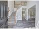 Bright foyer with hardwood floors, stairs with white railing, and a view into other rooms at 863 Fairlong Nw Way, Acworth, GA 30101