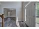 Bright foyer with hardwood floors, view to front yard, and stairs with white railing at 863 Fairlong Nw Way, Acworth, GA 30101