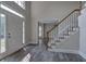 Bright foyer with hardwood floors, stairs with white railing, and a view into other rooms at 863 Fairlong Nw Way, Acworth, GA 30101