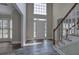 Bright foyer with hardwood floors, stairs with white railing, and a view into other rooms at 863 Fairlong Nw Way, Acworth, GA 30101