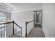 Open hallway with decorative chandelier, staircase and view of the entry at 863 Fairlong Nw Way, Acworth, GA 30101