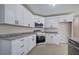 Charming kitchen featuring white cabinets, granite countertops, and stainless steel appliances at 863 Fairlong Nw Way, Acworth, GA 30101