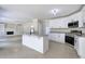 Modern kitchen featuring an island with granite countertop, white cabinets, stainless steel appliances, and tile flooring at 863 Fairlong Nw Way, Acworth, GA 30101