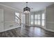 Inviting living area boasts gray wood flooring, light walls, and large windows with bright, natural light at 863 Fairlong Nw Way, Acworth, GA 30101