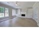 Bright living room features neutral tile floors, many windows, built-in shelving, and a painted brick fireplace at 863 Fairlong Nw Way, Acworth, GA 30101