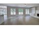 Bright living room features neutral tile floors, many windows, built-in shelving, and a painted brick fireplace at 863 Fairlong Nw Way, Acworth, GA 30101