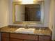 Bathroom vanity with a large mirror, granite countertop, sink, and under-cabinet storage at 219 Park Avenue, Woodstock, GA 30188