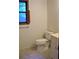 Bathroom with tiled floors, toilet and window with decorative shutters at 219 Park Avenue, Woodstock, GA 30188