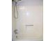 This bathtub has a white surround with a chrome faucet, spout and shower head at 219 Park Avenue, Woodstock, GA 30188