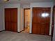 Comfortable bedroom featuring two closets, neutral carpet, and convenient access to an ensuite bathroom at 219 Park Avenue, Woodstock, GA 30188