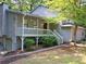 Side view of home showing attached garage, gray siding, front porch, and stairs to front door at 219 Park Avenue, Woodstock, GA 30188
