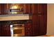 Gourmet kitchen featuring stainless steel appliances, dark cabinets, granite countertops, and custom storage at 219 Park Avenue, Woodstock, GA 30188