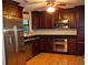 Gourmet kitchen featuring stainless steel appliances, and dark cabinetry with granite counters at 219 Park Avenue, Woodstock, GA 30188
