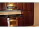 Well-appointed kitchen with stainless steel appliances and dark cabinets, featuring granite countertops at 219 Park Avenue, Woodstock, GA 30188