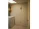 Bright laundry room features tile flooring and includes modern washing machine at 219 Park Avenue, Woodstock, GA 30188