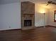Living room featuring vaulted ceilings and a beautiful stone fireplace with a raised hearth at 219 Park Avenue, Woodstock, GA 30188