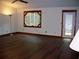 Bright living room with hardwood floors, unique window, and access to outdoor deck at 219 Park Avenue, Woodstock, GA 30188