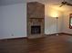 Cozy living room boasts a stone fireplace and dark hardwood flooring at 219 Park Avenue, Woodstock, GA 30188