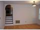 Bright living room with hardwood floors, arched doorways, and natural light from a window at 219 Park Avenue, Woodstock, GA 30188