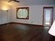 Open-concept living room with hardwood floors, a ceiling fan, and unique window at 219 Park Avenue, Woodstock, GA 30188