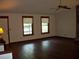 Spacious living room with gleaming hardwood floors and windows showing lovely outside view at 219 Park Avenue, Woodstock, GA 30188