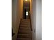 Carpeted staircase with wood railing leading to the upper level of the home at 219 Park Avenue, Woodstock, GA 30188