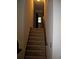 Carpeted stairway with wooden railing leads upstairs, bathed in natural light at 219 Park Avenue, Woodstock, GA 30188