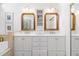 Bright bathroom with dual sinks, ample storage, and unique gold framed mirrors at 4729 Woodland Brook Se Ct, Atlanta, GA 30339