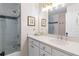 Elegant bathroom featuring a shower-over-tub and white vanity with neutral-toned countertop at 4729 Woodland Brook Se Ct, Atlanta, GA 30339