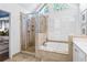 This bathroom features a walk-in shower, soaking tub, and a vanity area at 4729 Woodland Brook Se Ct, Atlanta, GA 30339