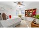 This bedroom features a ceiling fan, natural light, and a decorative bookcase at 4729 Woodland Brook Se Ct, Atlanta, GA 30339