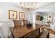 Dining room view with hardwood floors, elegant lighting, and easy access to the living room at 4729 Woodland Brook Se Ct, Atlanta, GA 30339
