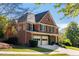 Charming brick home with a two-car garage, manicured lawn, and inviting curb appeal at 4729 Woodland Brook Se Ct, Atlanta, GA 30339