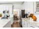 Modern kitchen featuring white cabinetry, stainless steel appliances, and marble countertops at 4729 Woodland Brook Se Ct, Atlanta, GA 30339