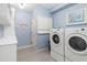 Neat laundry room with a washer and dryer, complemented by custom cabinets for storage at 4729 Woodland Brook Se Ct, Atlanta, GA 30339