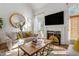 Bright living room with fireplace, large mirror and neutral-toned furnishings at 4729 Woodland Brook Se Ct, Atlanta, GA 30339